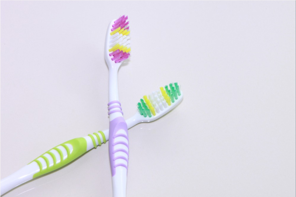 Two toothbrushes crossed on counter Dentist in Centreville